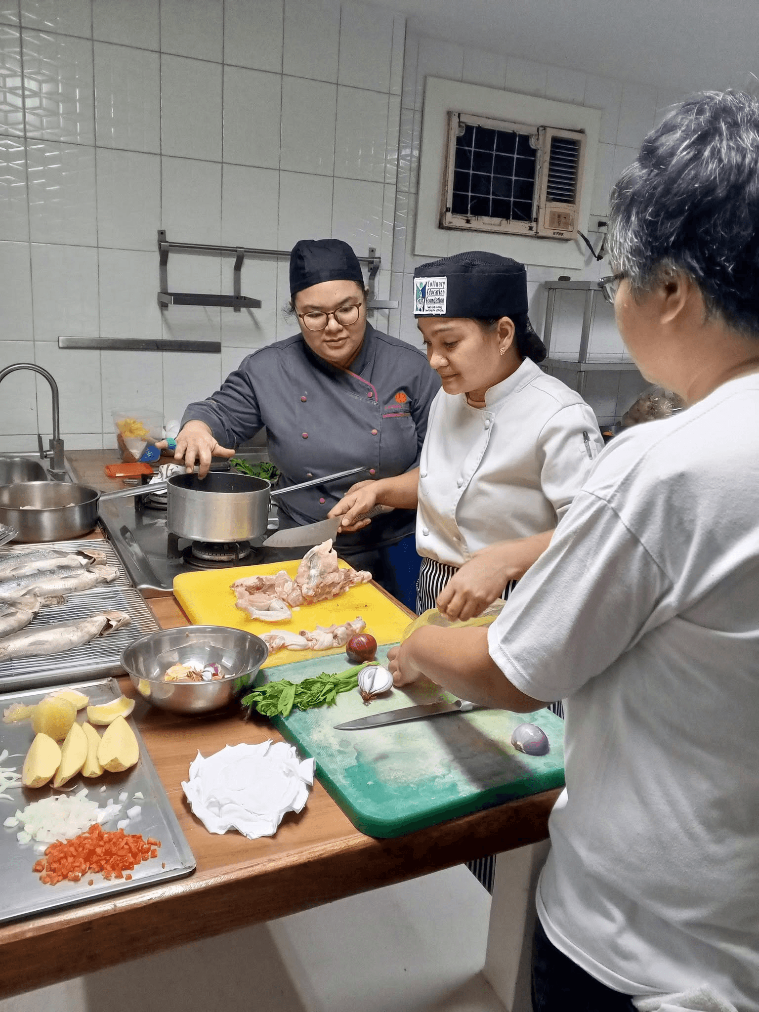 Chefs preparing food together during Green Chefmanship training