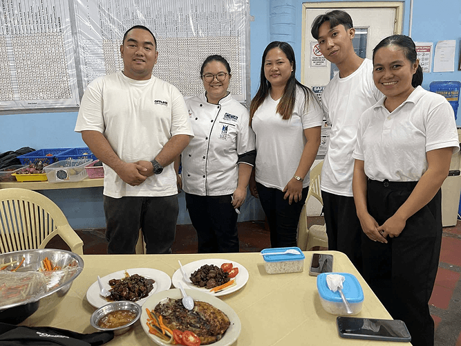 CCA Manila chefs and trainees with a finished meal
